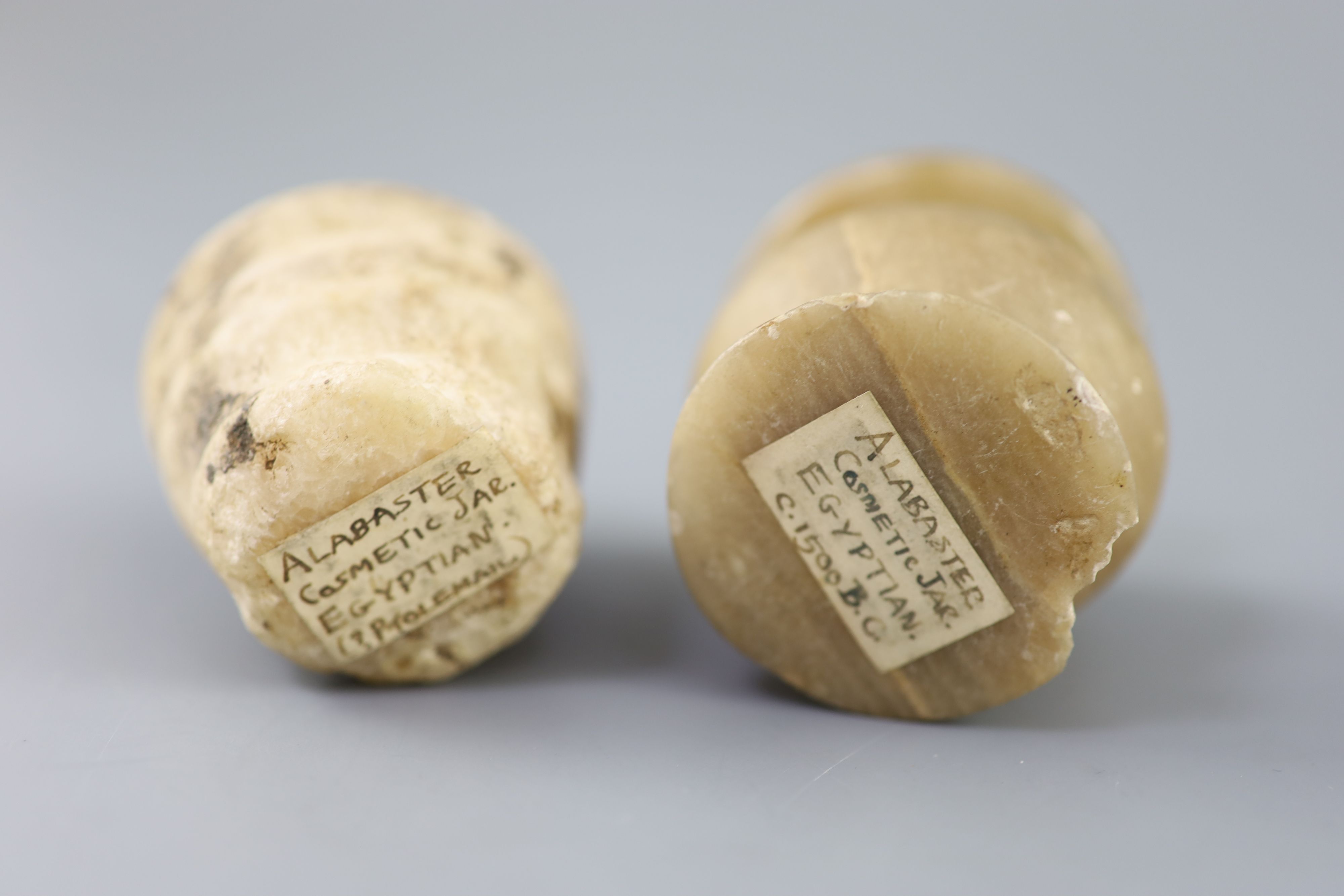 Two Egyptian alabaster cosmetic jars, c.1500 BC and Ptolemaic period (305-30 BC), Provenance - A. T. Arber-Cooke